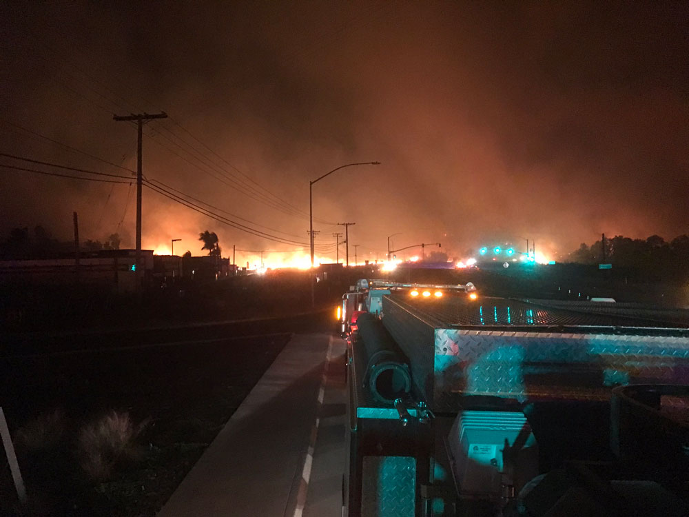 Wildfire burns in a California neighborhood.