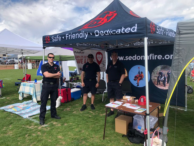 Firefighters in the SFD booth at a public event.