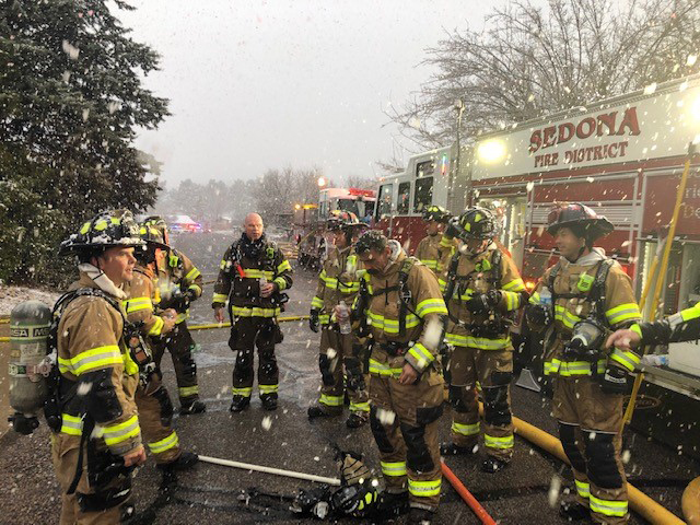 Picture of SFD firefighters on scene with snow falling.