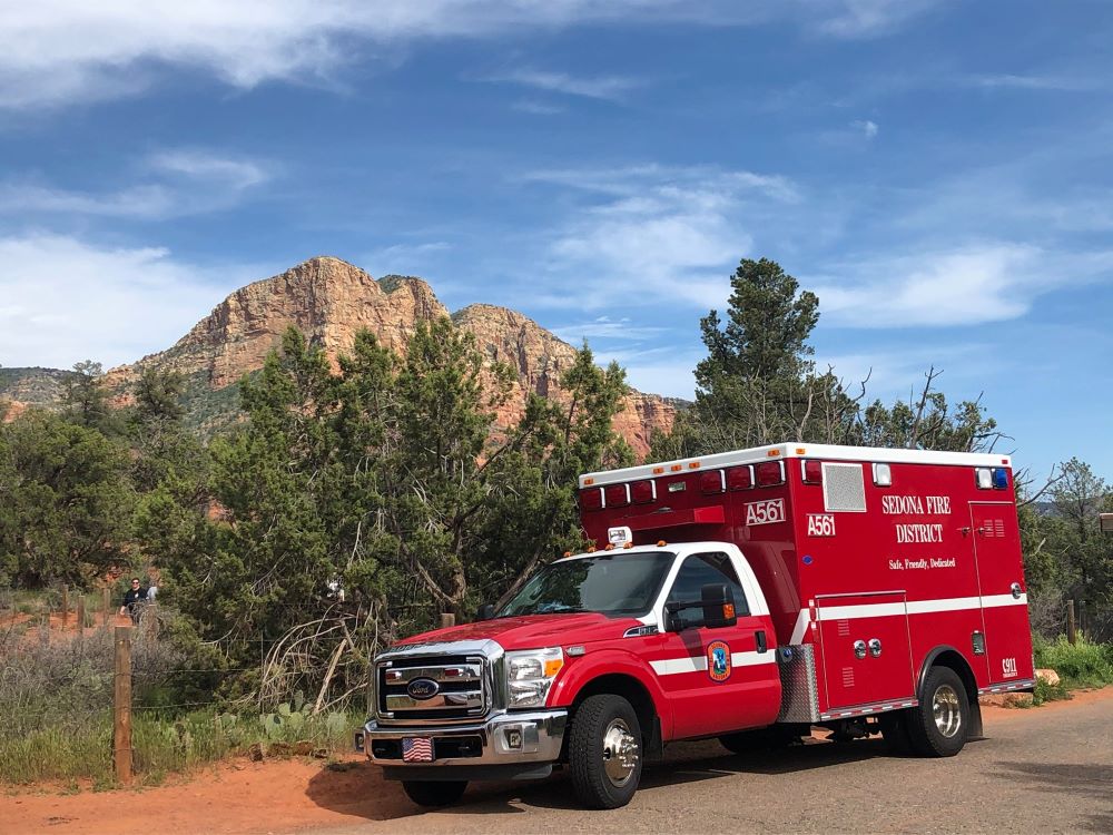 Ambulance 561 pictured in front of a scenic backdrop.